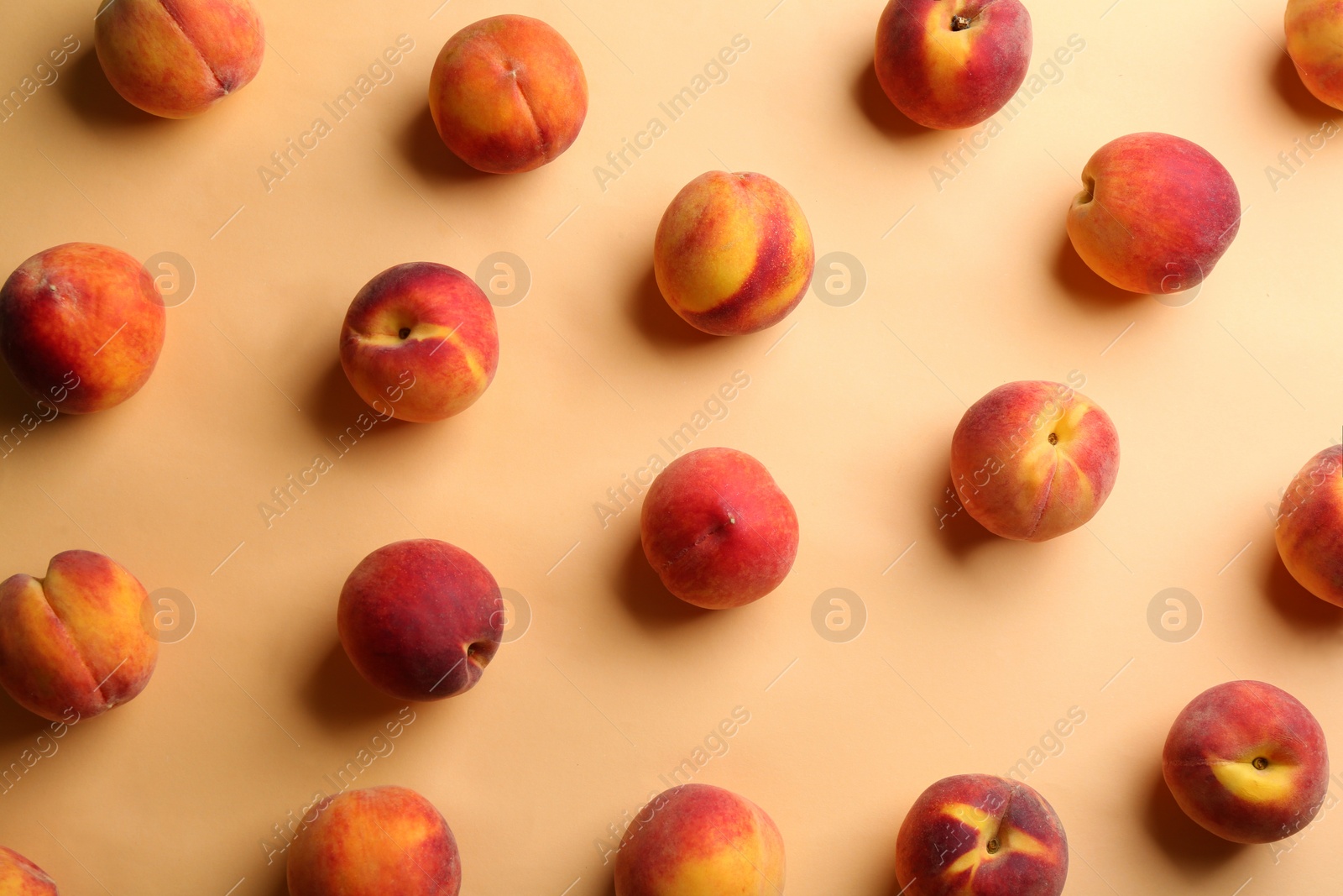 Photo of Fresh ripe peaches on beige background, flat lay