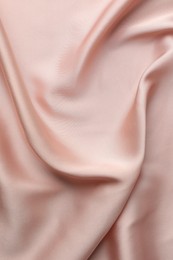 Photo of Crumpled pink silk fabric as background, top view