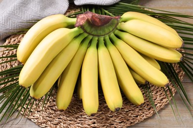 Bunch of ripe baby bananas on wooden table