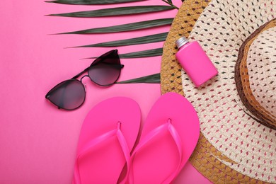 Photo of Flat lay composition with beach accessories on pink background