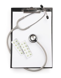 Photo of Stethoscope, pills and clipboard isolated on white, top view. Medical tool