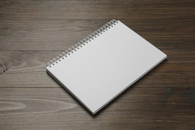 Photo of Blank paper brochure on wooden table. Mockup for design