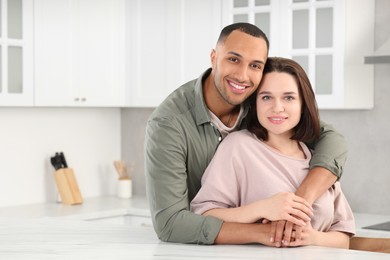 Photo of Dating agency. Happy couple spending time together in kitchen, space for text