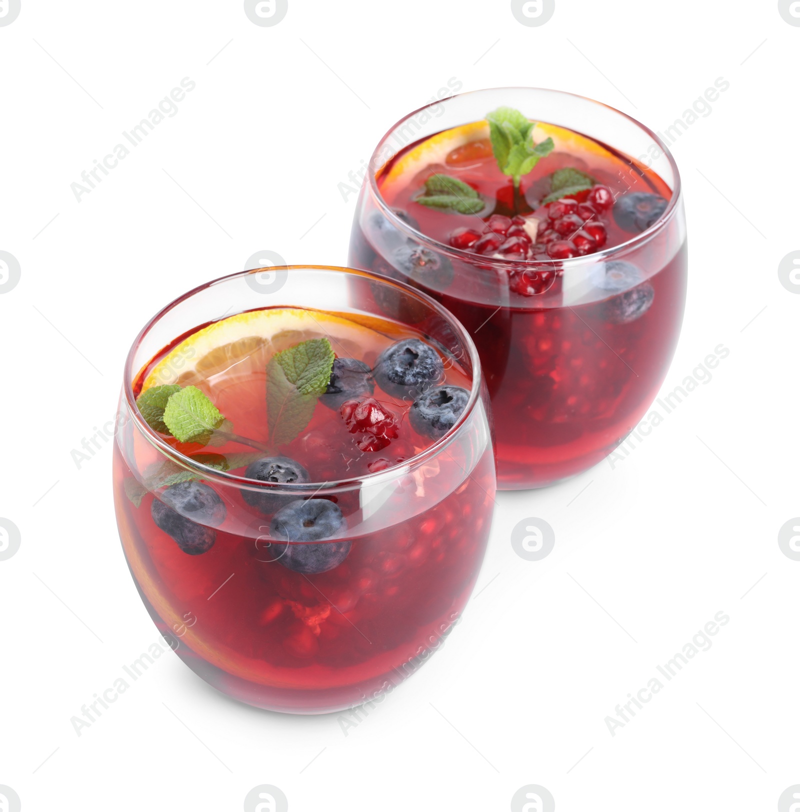 Photo of Aromatic Sangria drink in glasses isolated on white