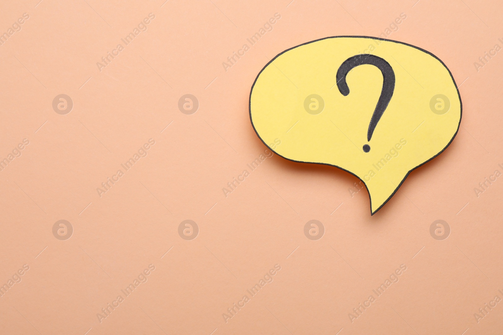 Photo of Paper speech bubble with question mark on beige background, top view. Space for text