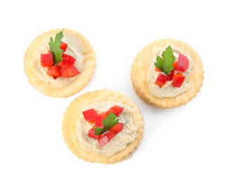 Photo of Delicious crackers with humus, bell pepper and parsley on white background, top view