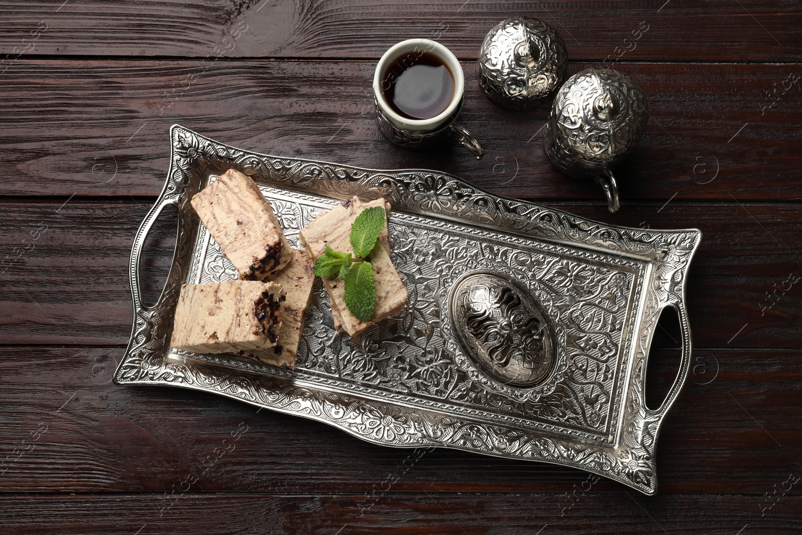 Photo of Tasty chocolate halva served on wooden table, flat lay