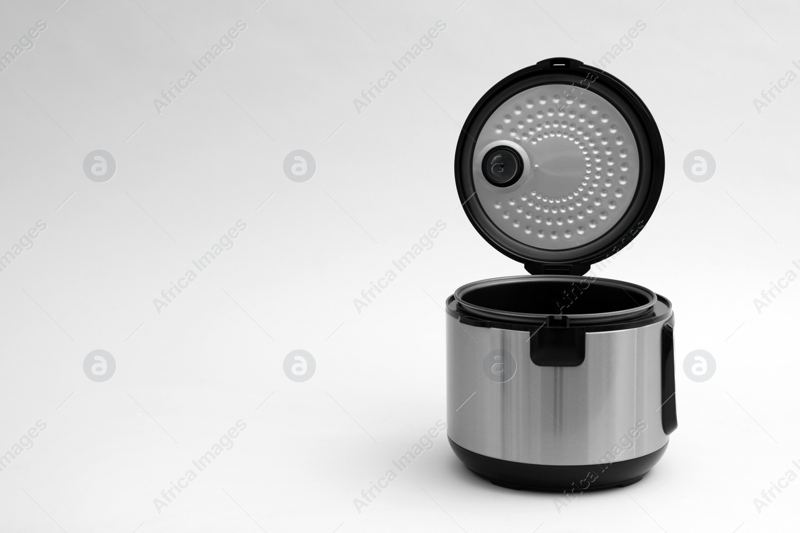 Photo of Modern electric multi cooker on light background. Space for text