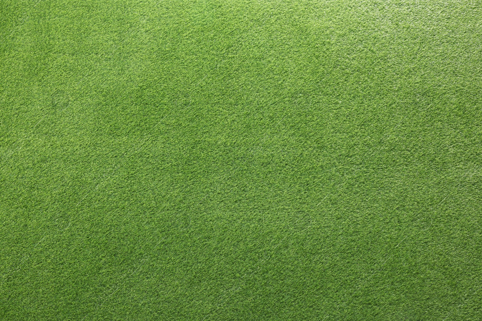 Photo of Green artificial grass as background, top view