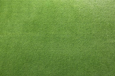 Photo of Green artificial grass as background, top view