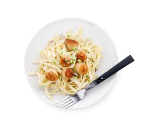 Delicious scallop pasta with onion and fork isolated on white, top view