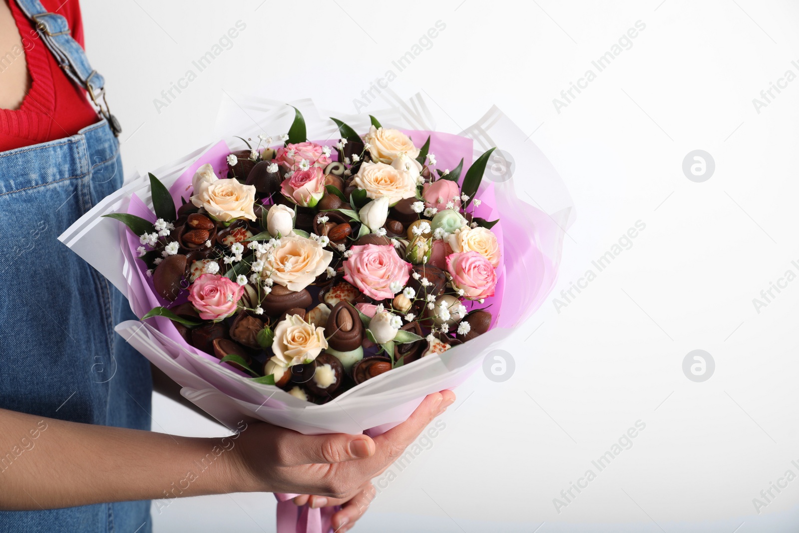 Photo of Woman with beautiful food bouquet on white background, closeup