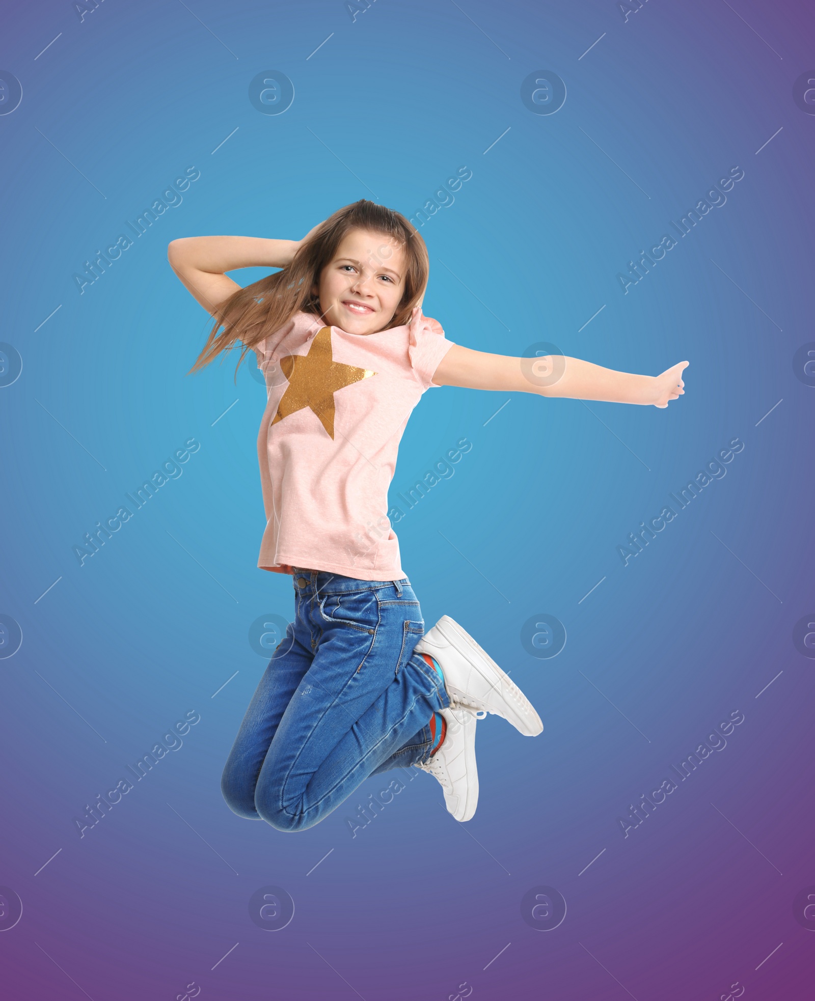 Image of Happy cute girl jumping on color gradient background