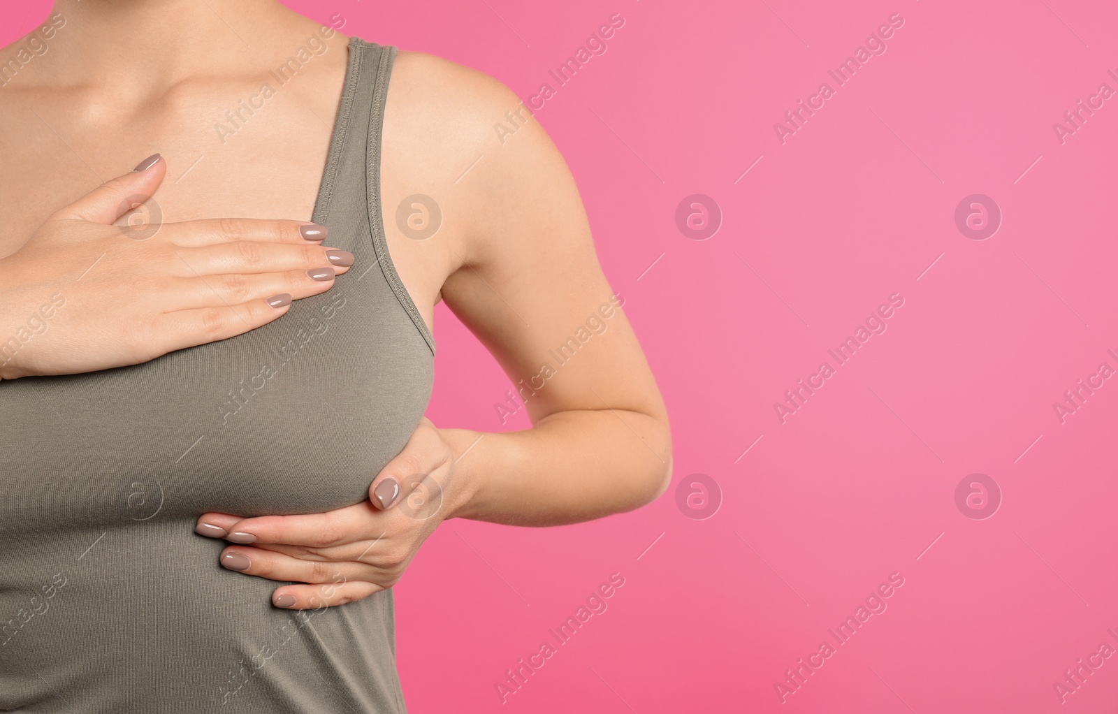 Photo of Woman checking her breast on color background, closeup. Space for text