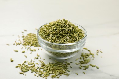 Fennel seeds in bowl on white table, closeup