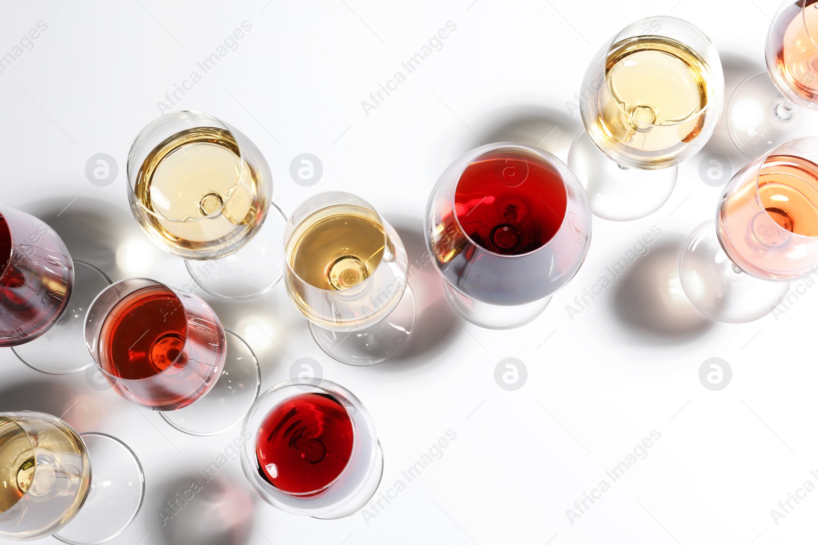 Photo of Different glasses with wine on white background, top view