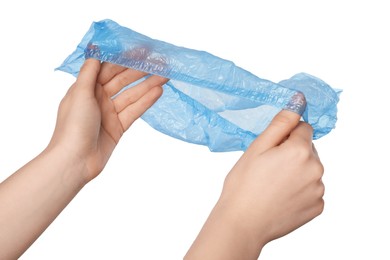 Woman holding blue shoe cover on white background, closeup