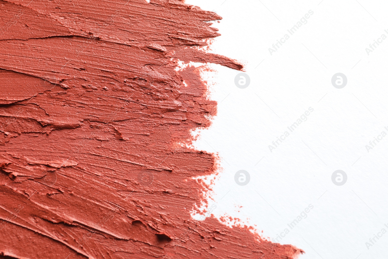 Photo of Strokes of lipstick on white background, top view