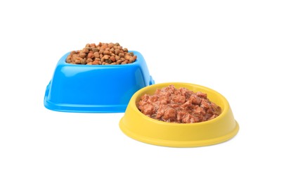 Dry and wet pet food in feeding bowls isolated on white