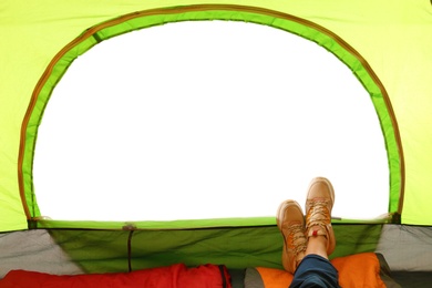 Closeup of female in camping tent on white background, view from inside