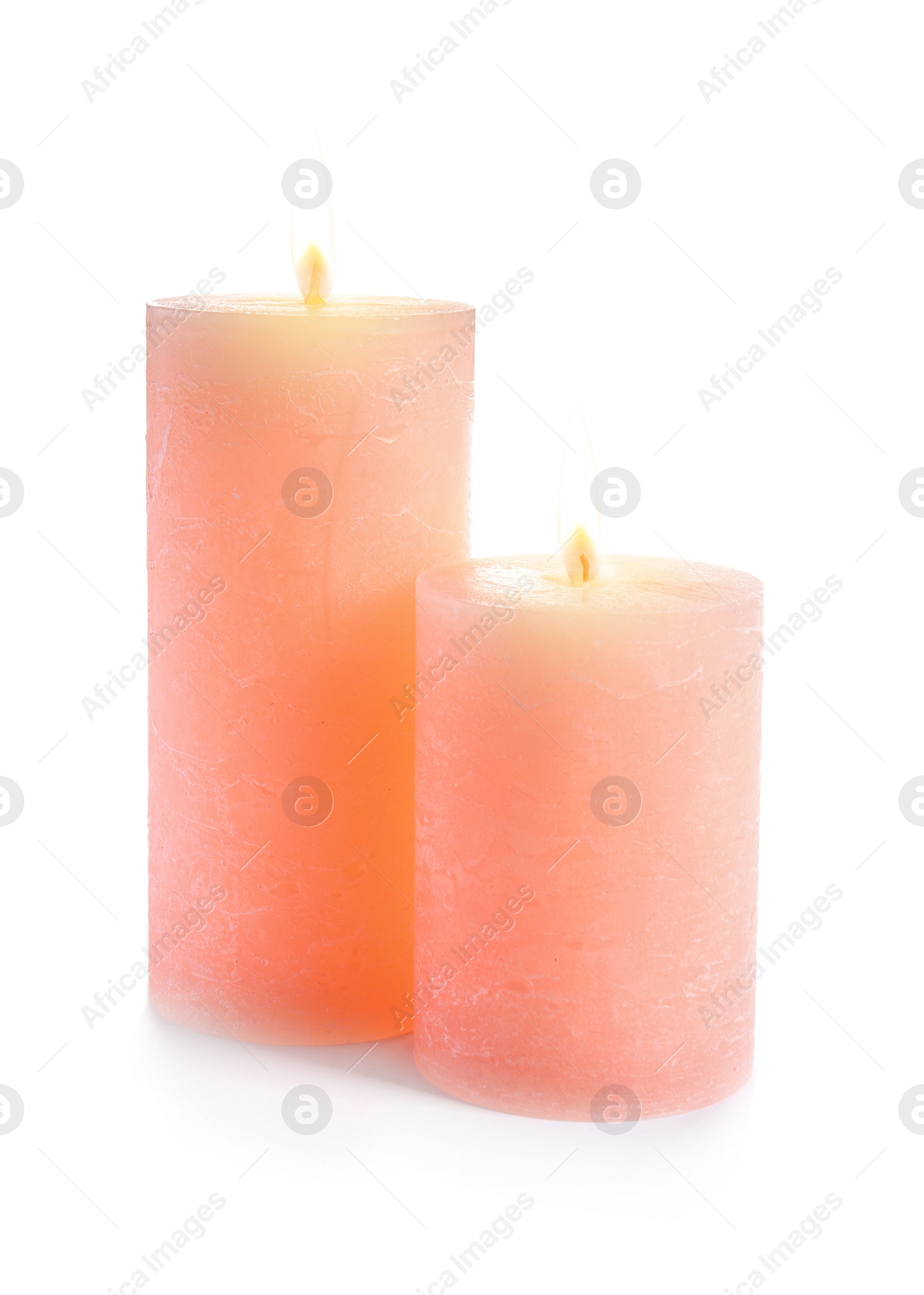 Photo of Two decorative pink wax candles on white background