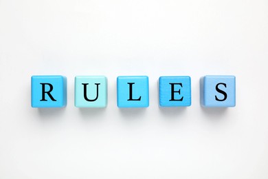 Photo of Word Rules made of wooden cubes with letters on white background, top view