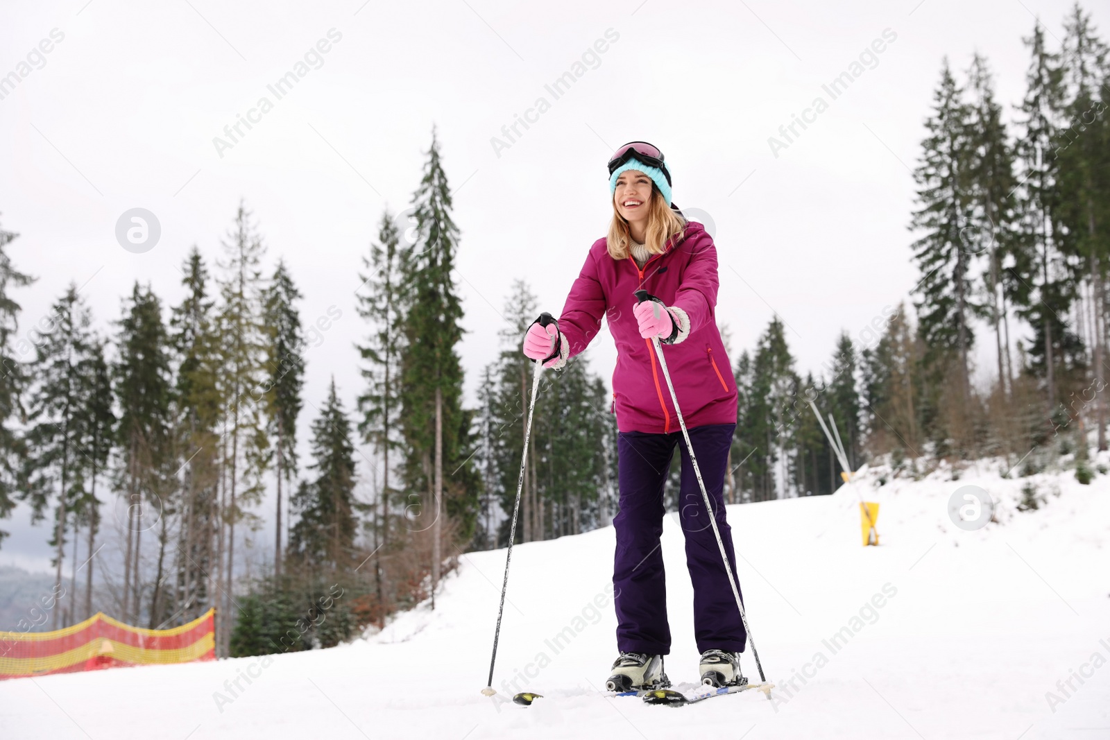 Photo of Female skier on slope at resort, space for text. Winter vacation