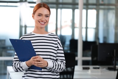 Photo of Happy woman clipboard in office, space for text