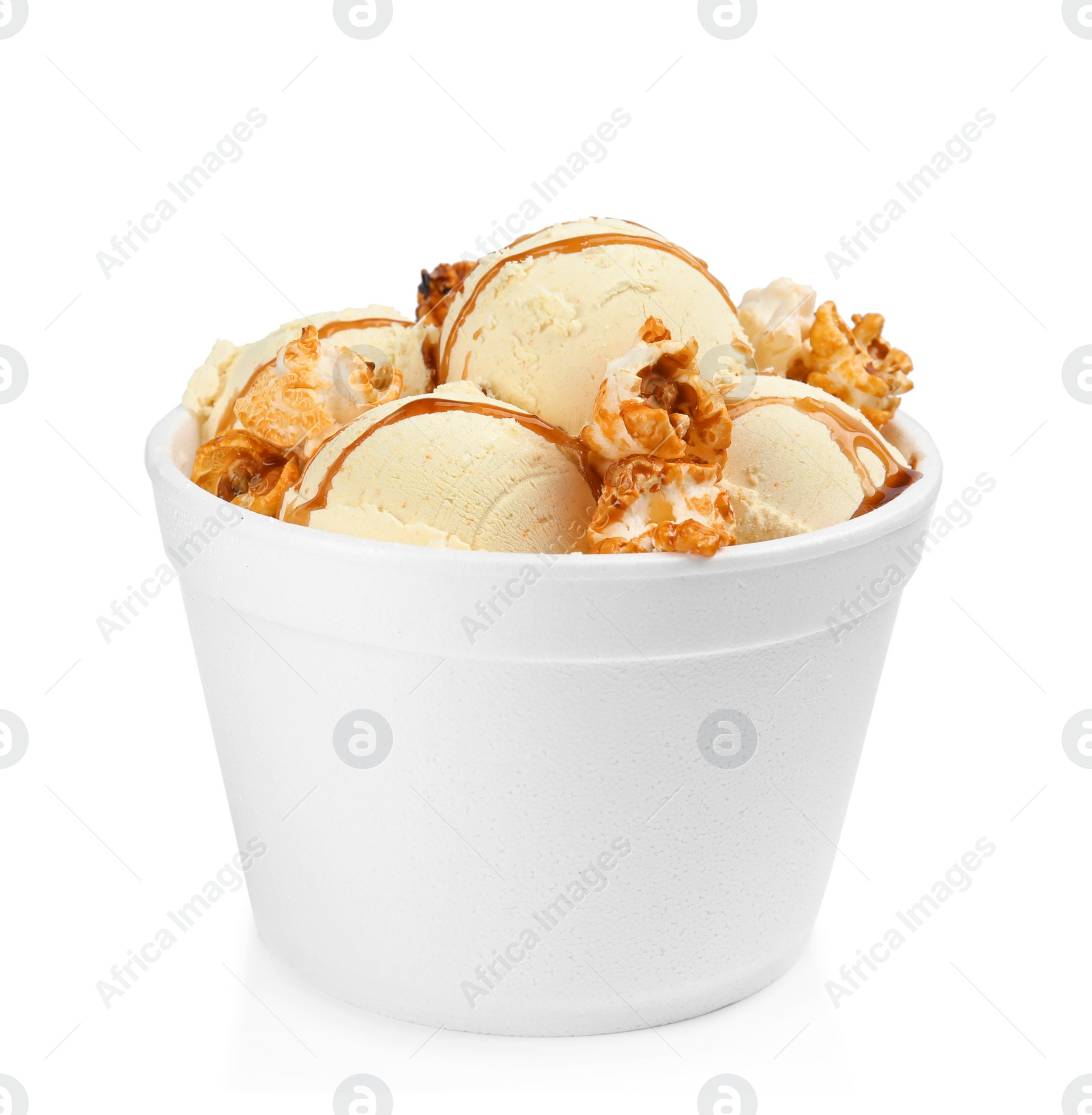 Photo of Delicious ice cream with caramel popcorn and sauce in dessert bowl on white background