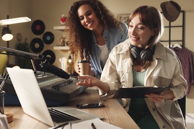Young women working in modern radio studio