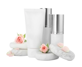 Photo of Cosmetic products, spa stones and flowers on white background