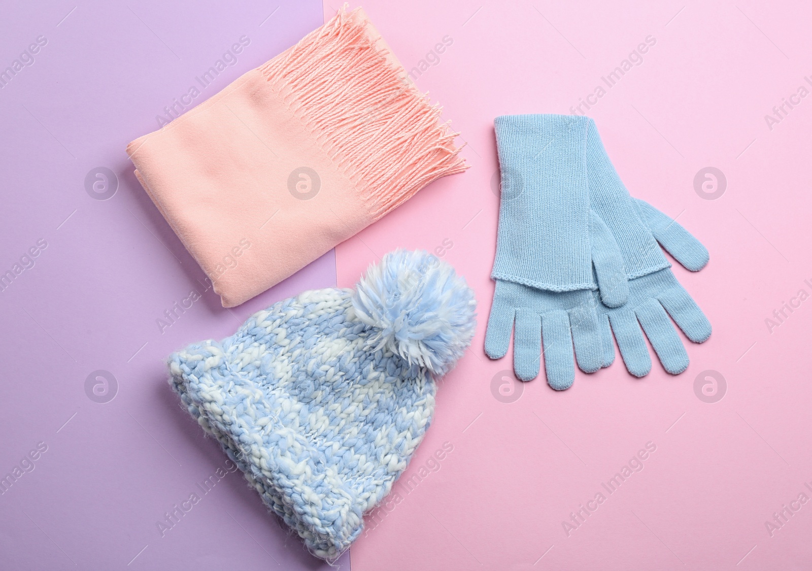 Photo of Flat lay composition with warm clothes on color background