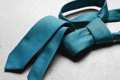 Photo of One blue necktie on light textured table, above view