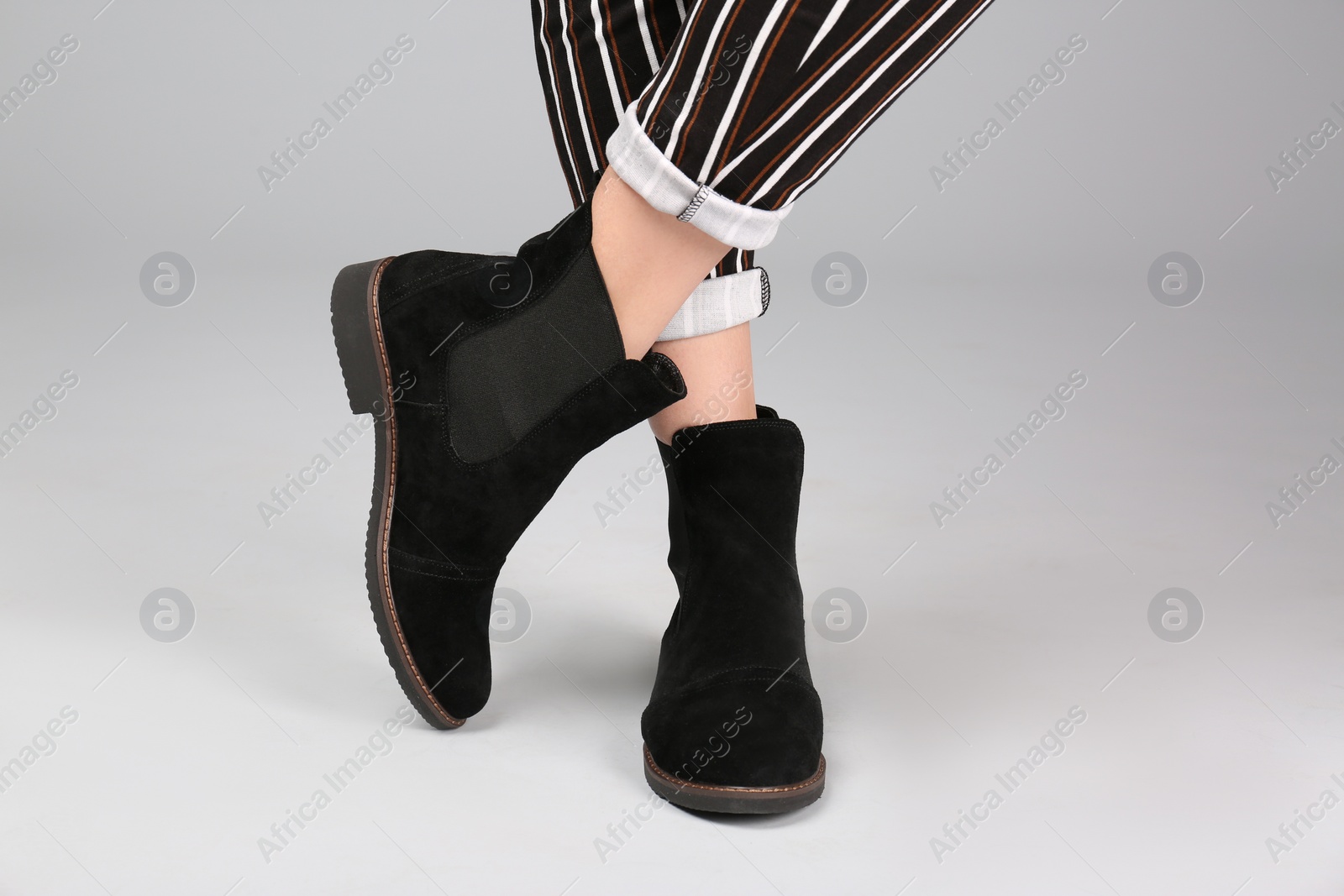 Photo of Woman in stylish shoes on light background