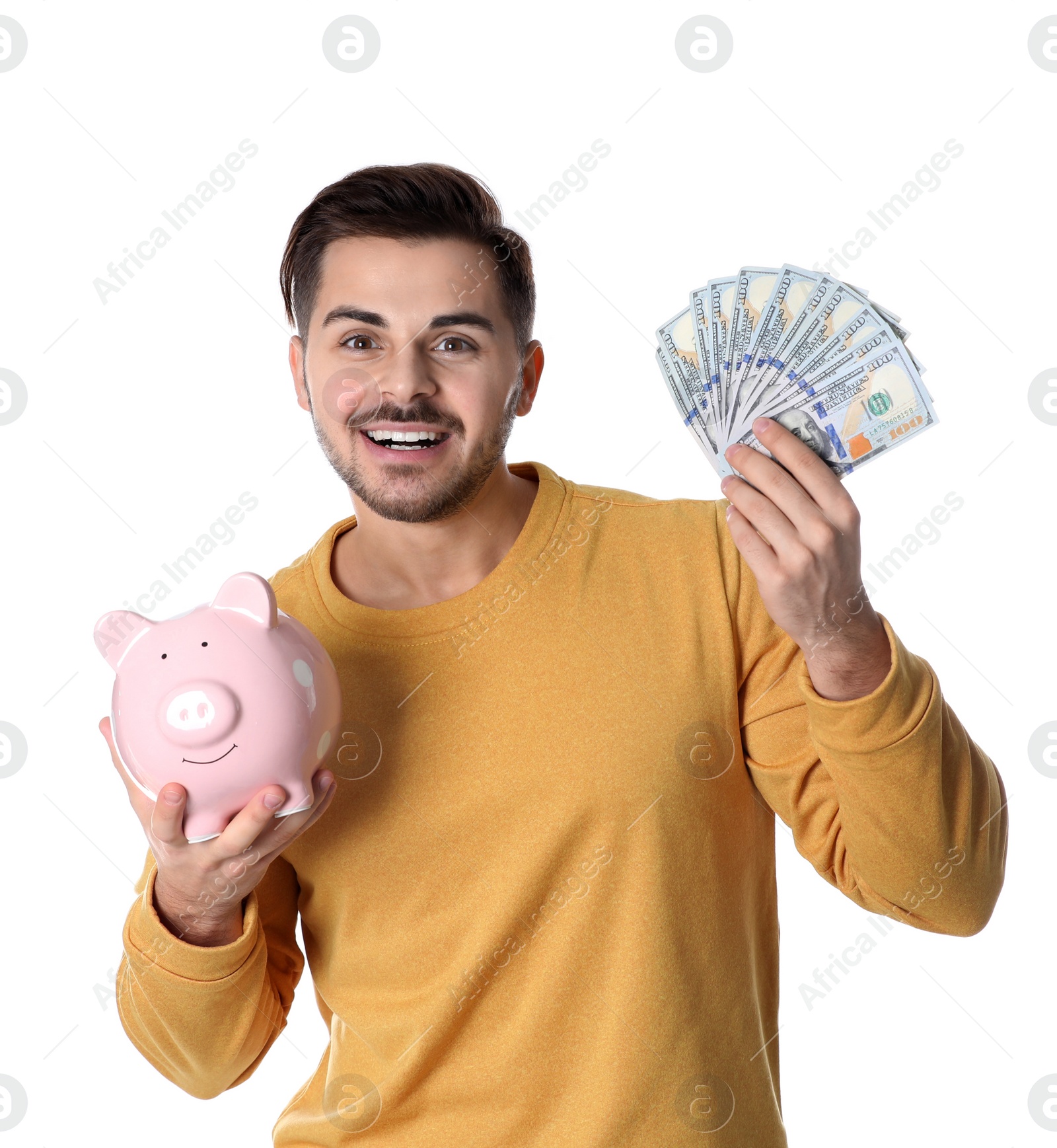 Photo of Young man with money and piggy bank on white background