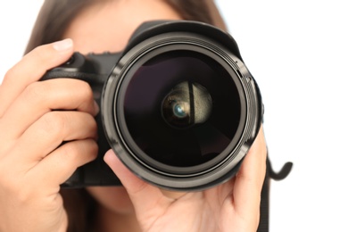 Female photographer with professional camera on light background, closeup