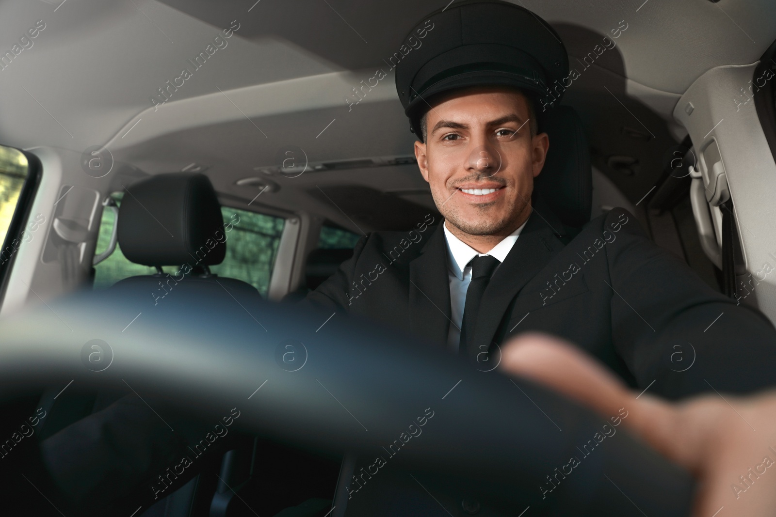 Photo of Professional driver in luxury car. Chauffeur service