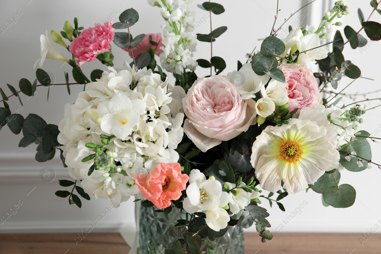 Photo of Bouquet of beautiful flowers in vase, closeup