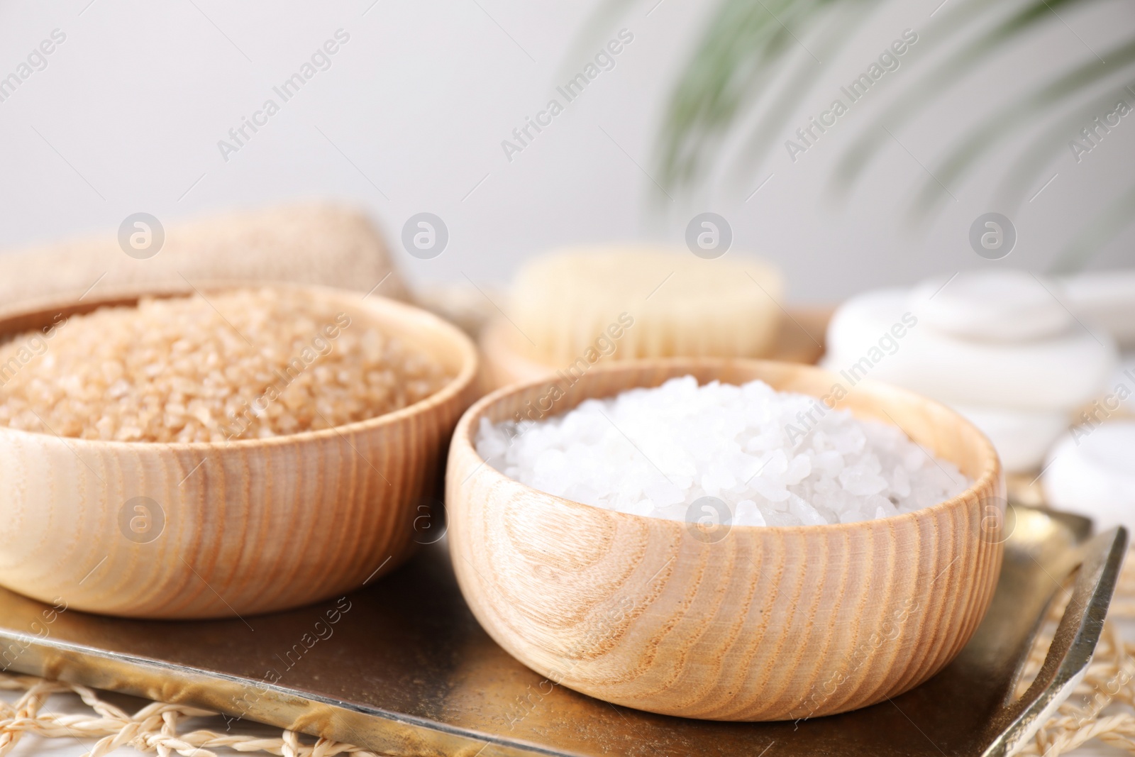 Photo of Salt for spa scrubbing procedure on tray, closeup