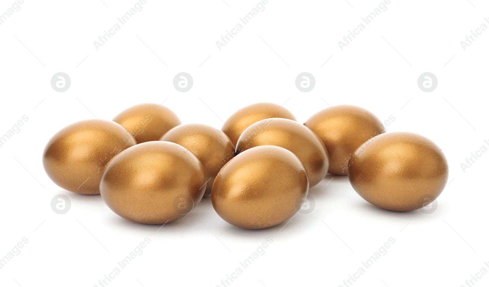 Photo of Many shiny golden eggs on white background