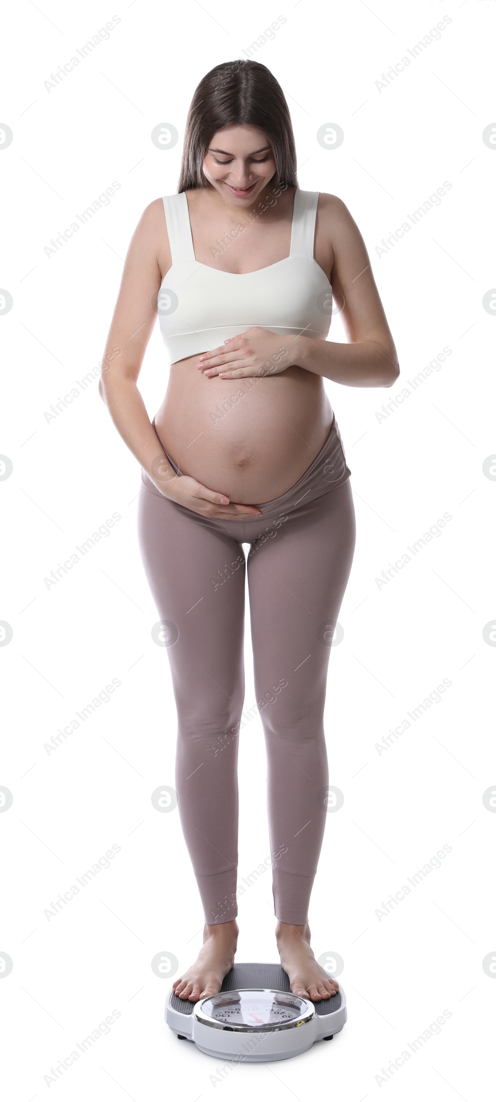 Photo of Pregnant woman standing on scales against white background