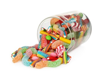 Glass jar with different candies on white background