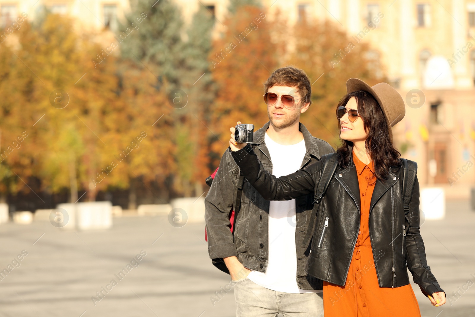 Photo of Couple of travelers with camera on city street