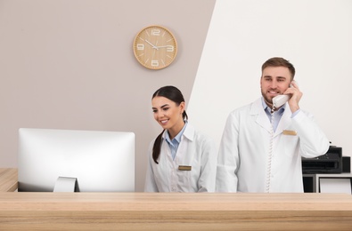 Professional staff working at reception in modern clinic
