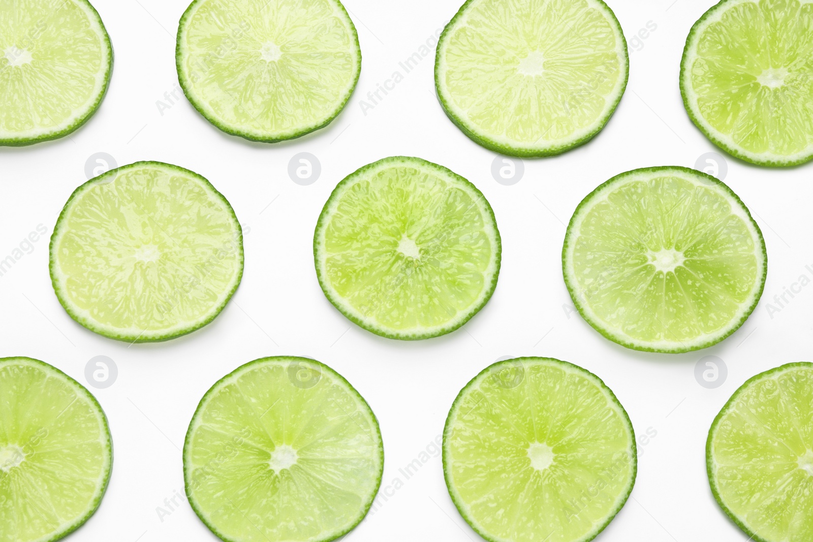 Photo of Fresh juicy lime slices on white background, top view