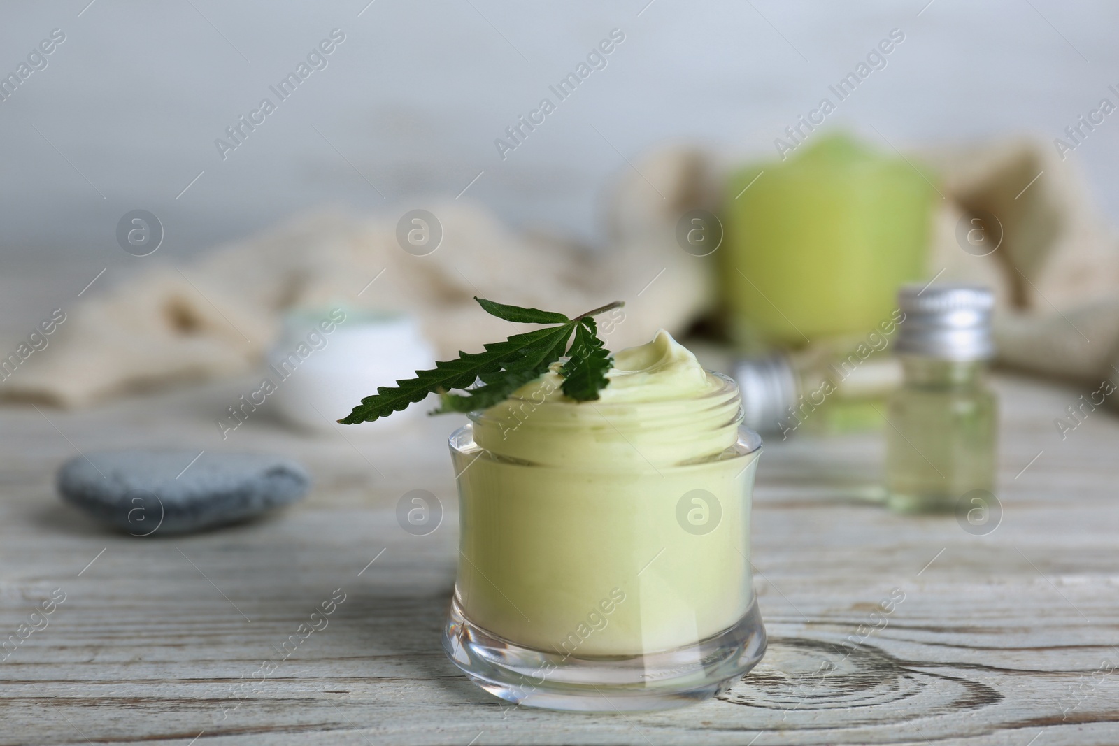 Photo of Jar of hemp lotion on wooden table