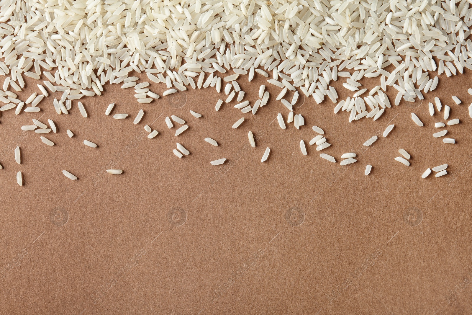 Photo of Long grain rice on color background, top view with space for text