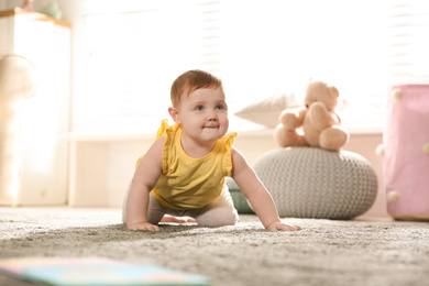 Cute little baby girl crawling at home