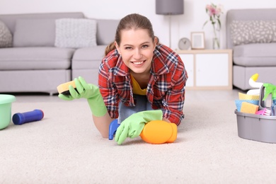 Woman cleaning carpet in living room