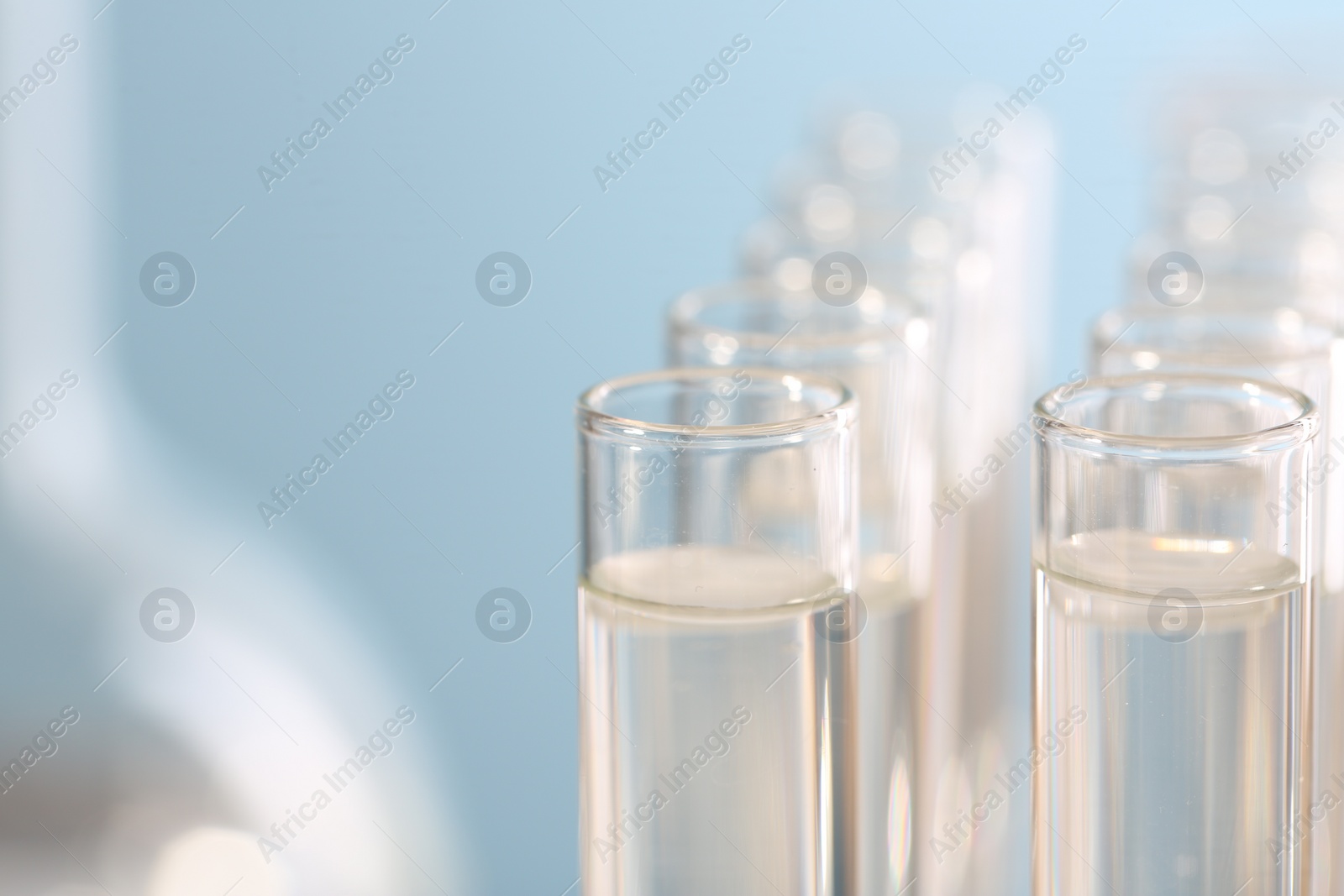 Photo of Laboratory analysis. Many glass test tubes on blurred background, closeup and space for text